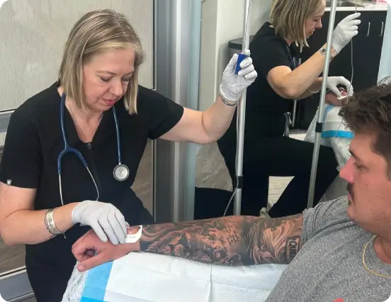 Nurse or medical professional administering IV therapy or regenerative treatment in a modern clinic